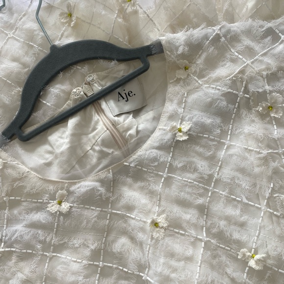 Stunning ivory white open cutting out with delicate flowers cute detailing. - Picture 7 of 16